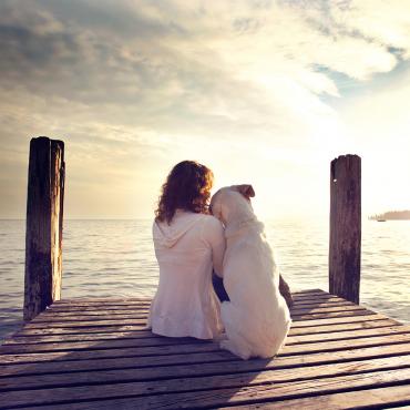 Lady with dog at sunset